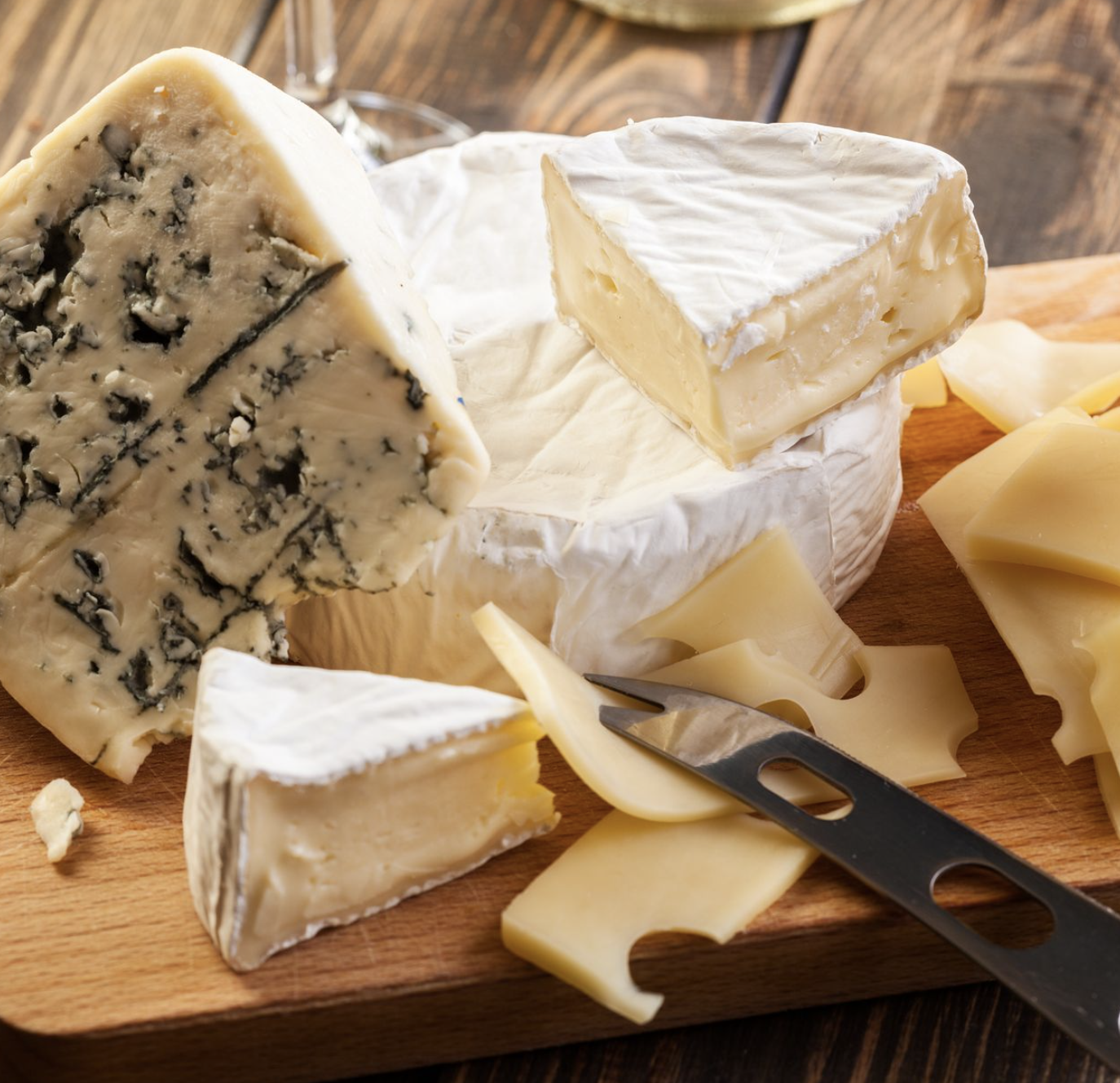 cutting board filled with varieties of cheeses